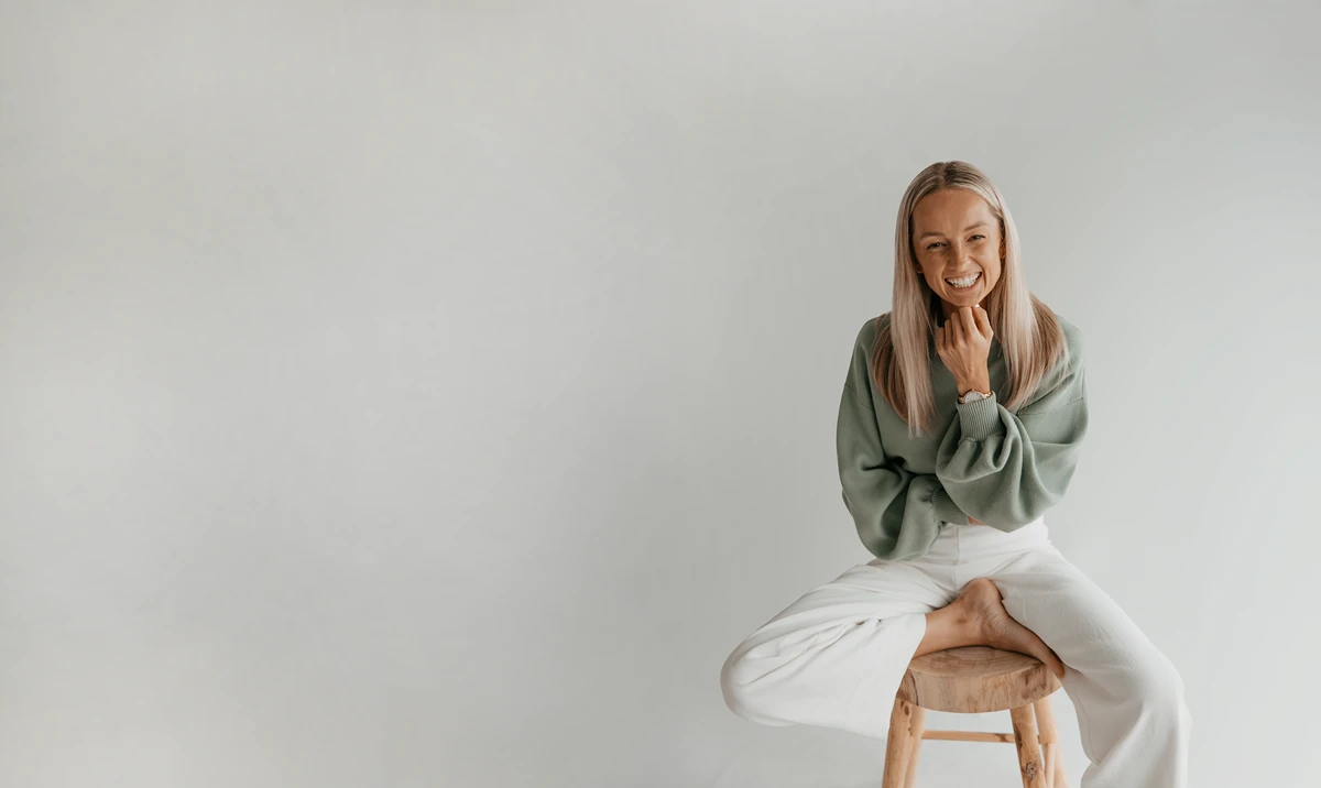 Smiling woman on a stool