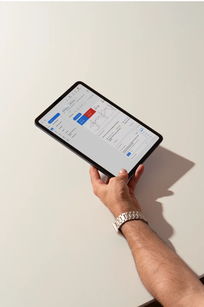 Hand holding an iPad displaying Google Analytics
